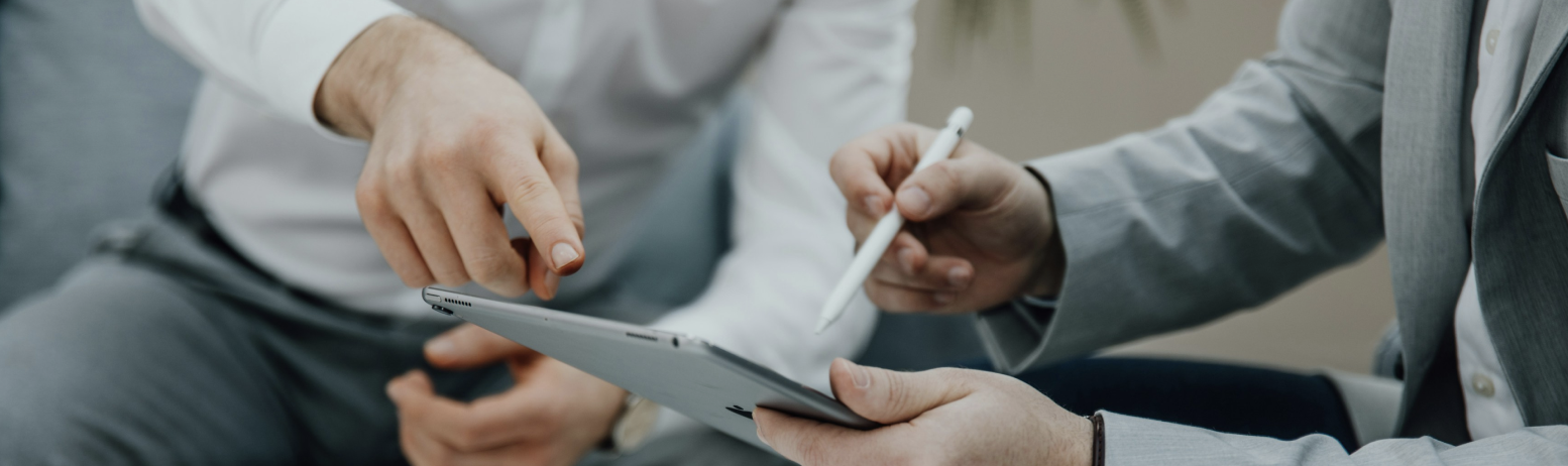 Professional team discussing financial strategies on a tablet